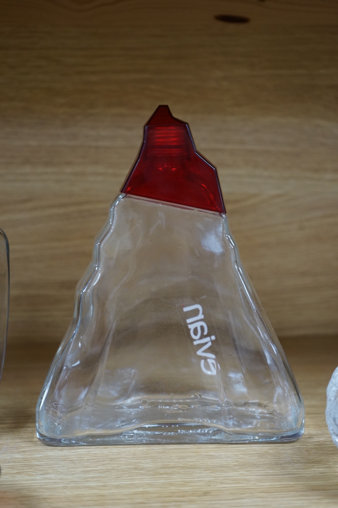 A collection of glassware including a Kosta Boda snowball pot and an Evian advertising water bottle, largest 23cm high